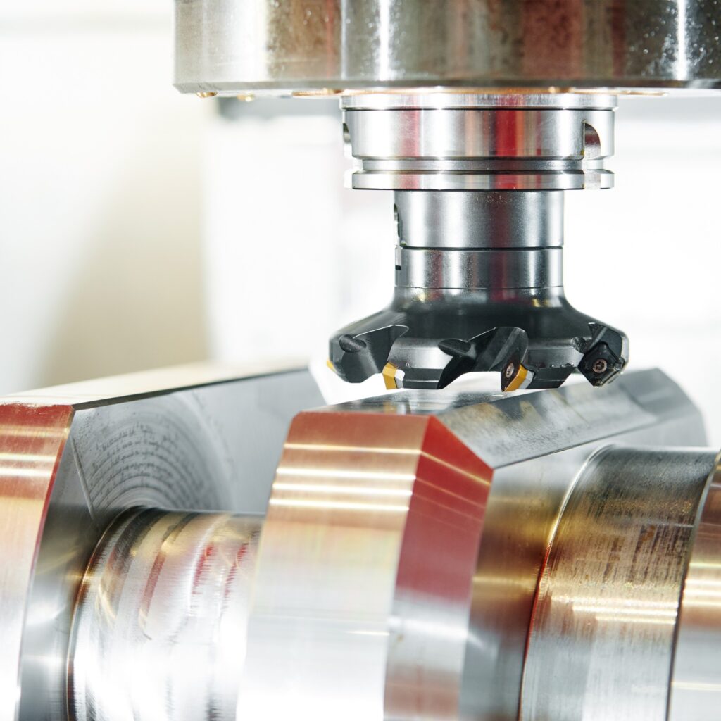 CNC milling head machining a titanium alloy workpiece at Neo Industries Corp